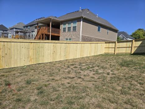 Wood privacy fence beside a residential backyard